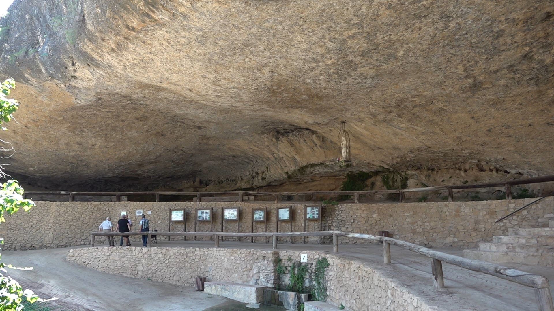 Visitants davant els plafons informatius de la cova de Santa Llúcia de la Bisbal de Montsant
